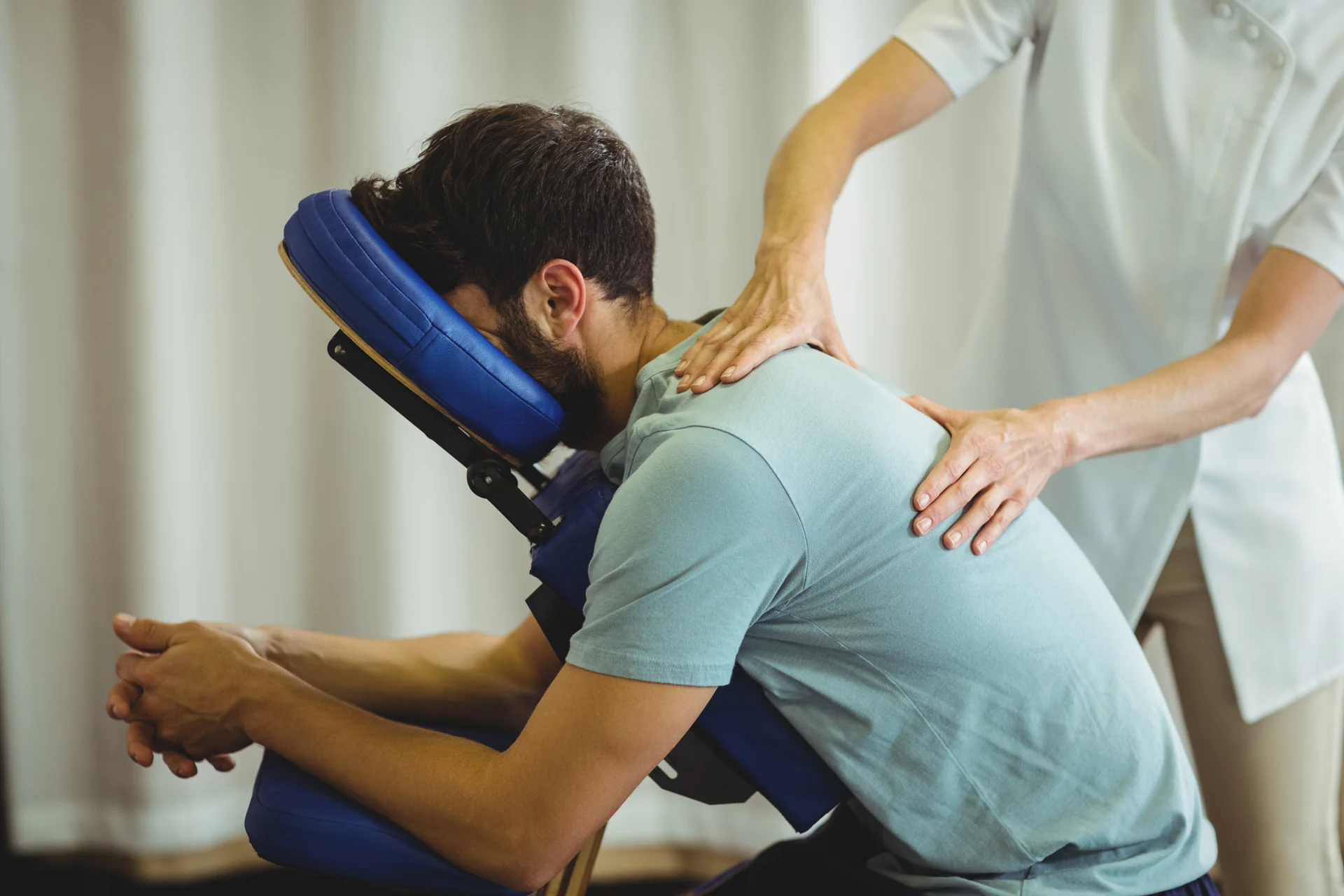 Seated patient receiving shoulder care