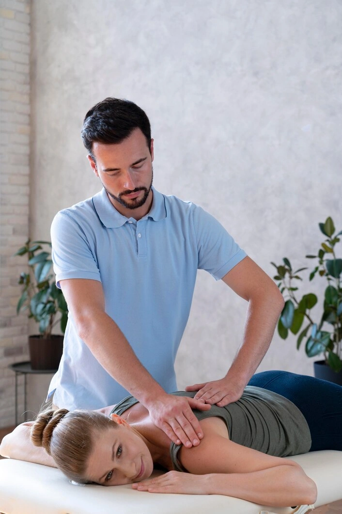 Practitioner working with a patient on a treatment table